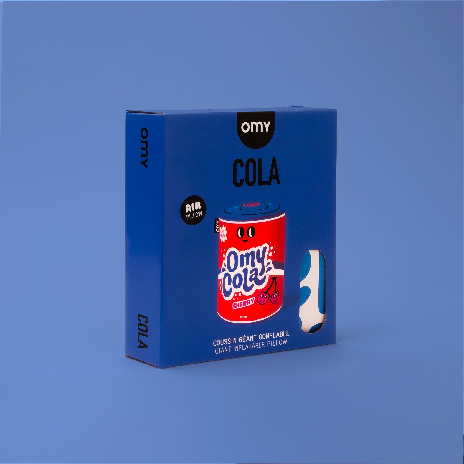 Blue packaging of Omy Cola inflatable pillow on a blue background