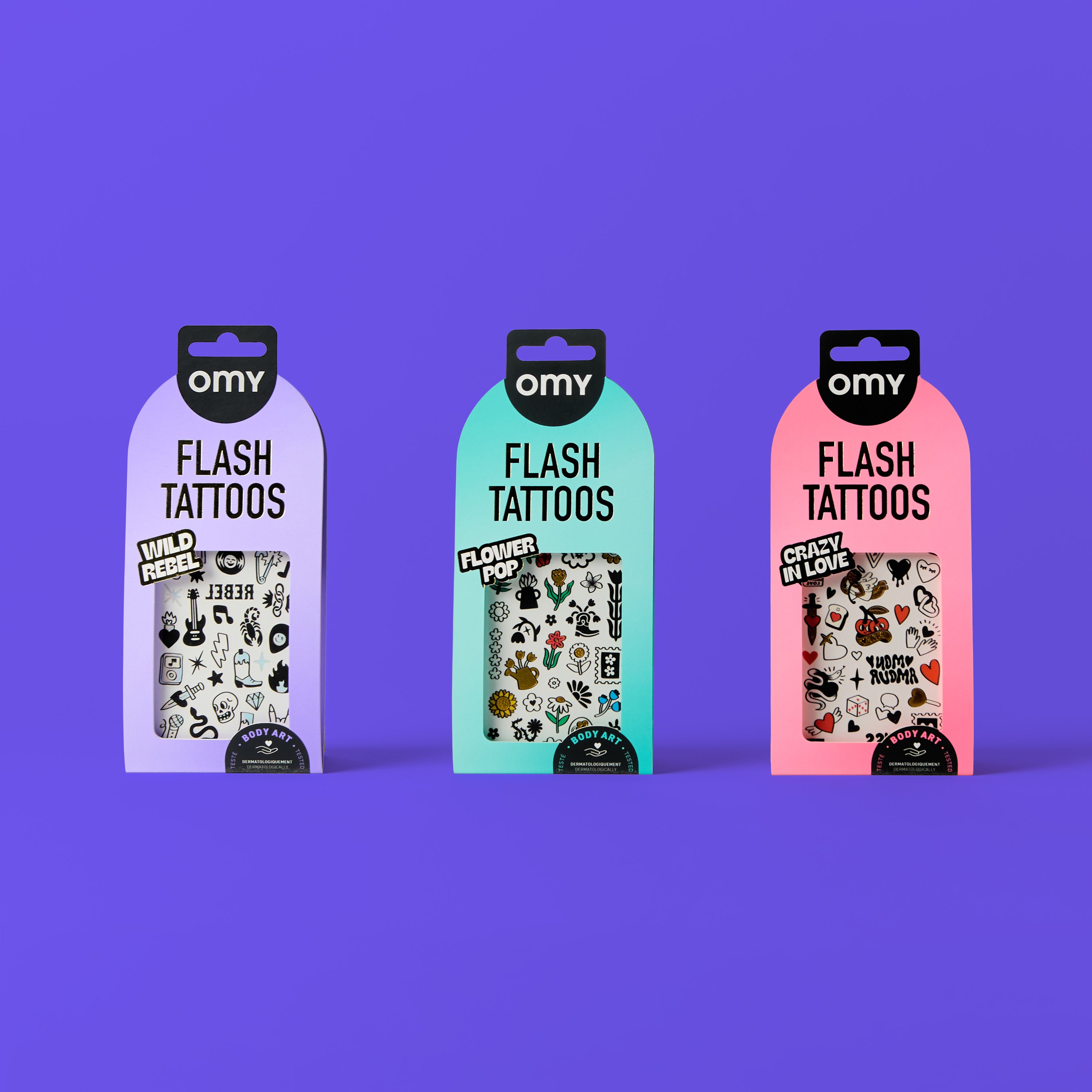 Three packages of omy flash tattoos on a purple background