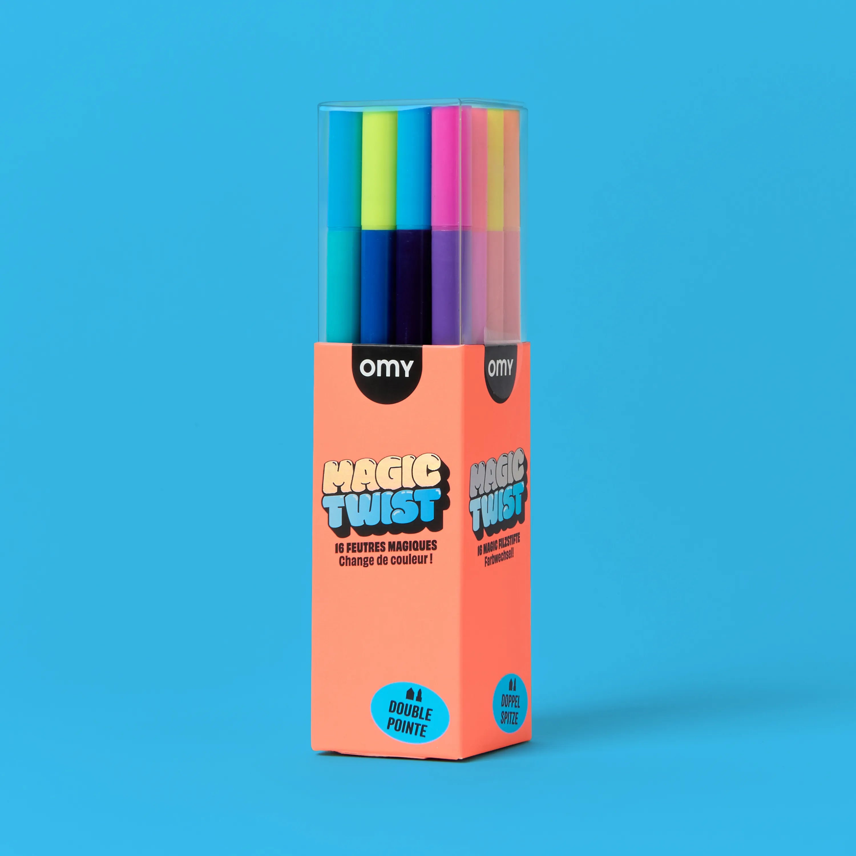 OMY Magic Twist 16 color-changing markers front packaging – coral box with dual-tip felt pens in yellow, pink, blue and purple on light blue background