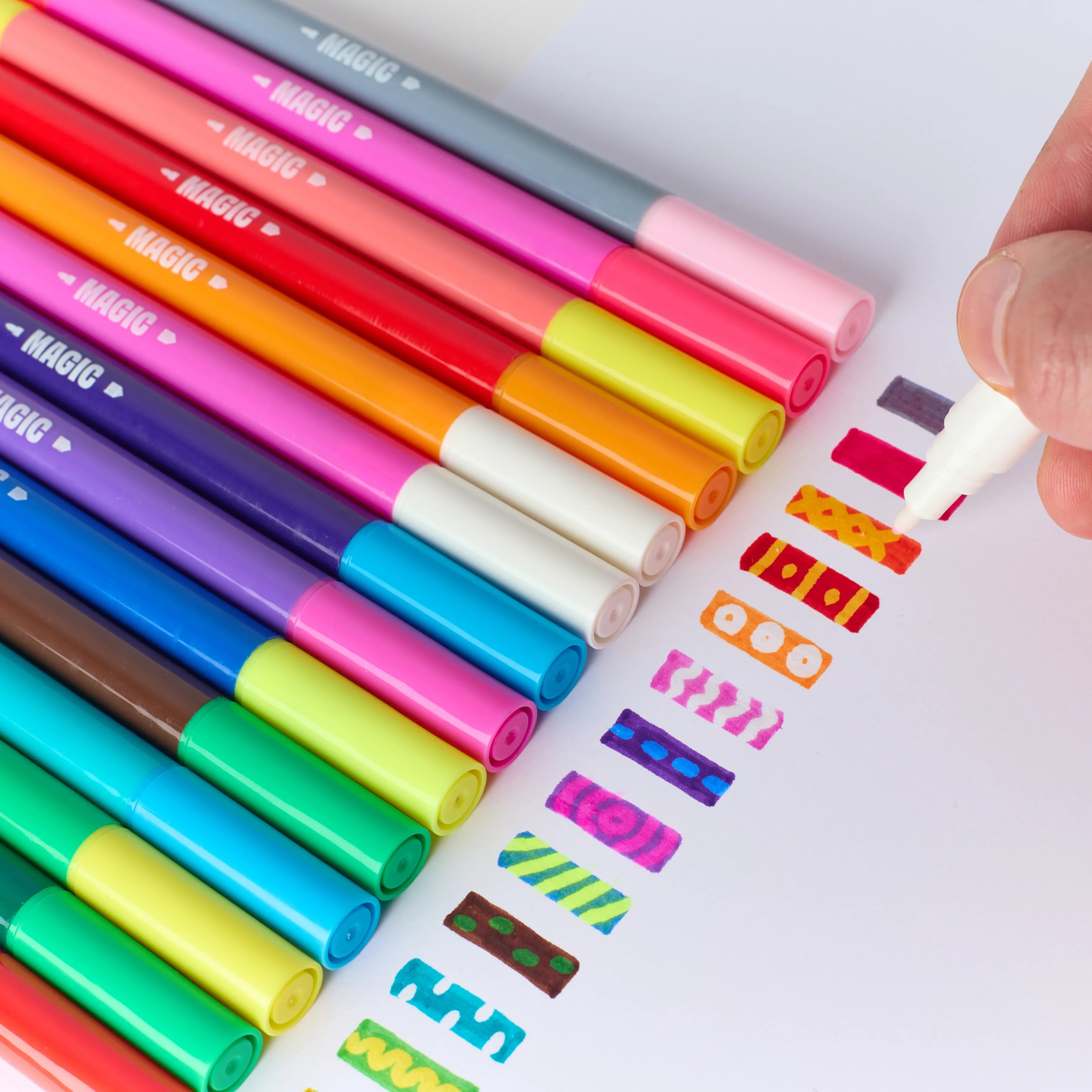 OMY Magic Twist 16 color-changing dual-tip markers fan display – rainbow of felt tip pens in pink, blue, orange, green, yellow and purple with colorful pattern swatches on white background