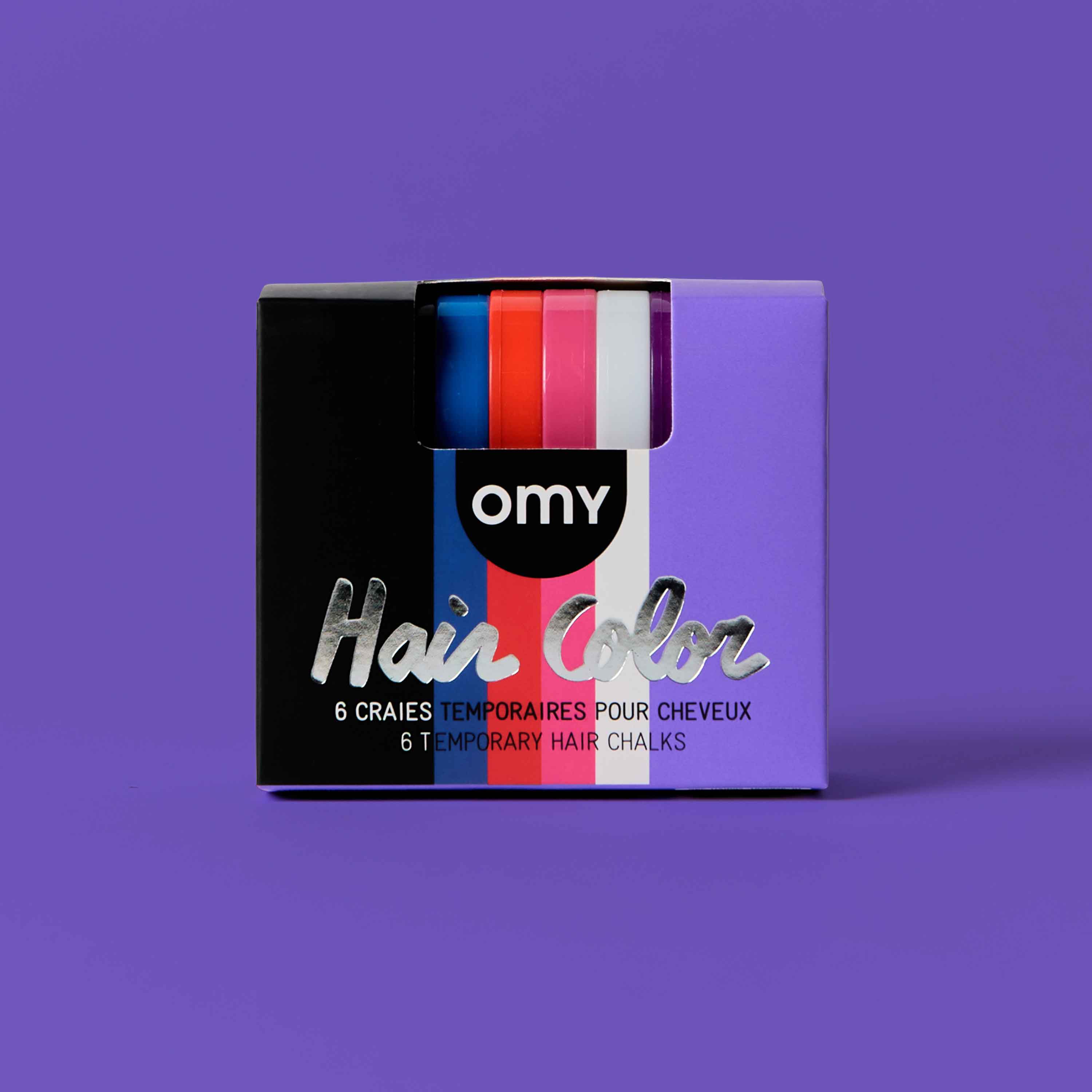 Box of OMY temporary hair chalks on a purple background