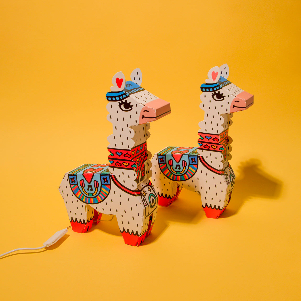 Two colorful lamp 3D Lama OMY on a yellow background