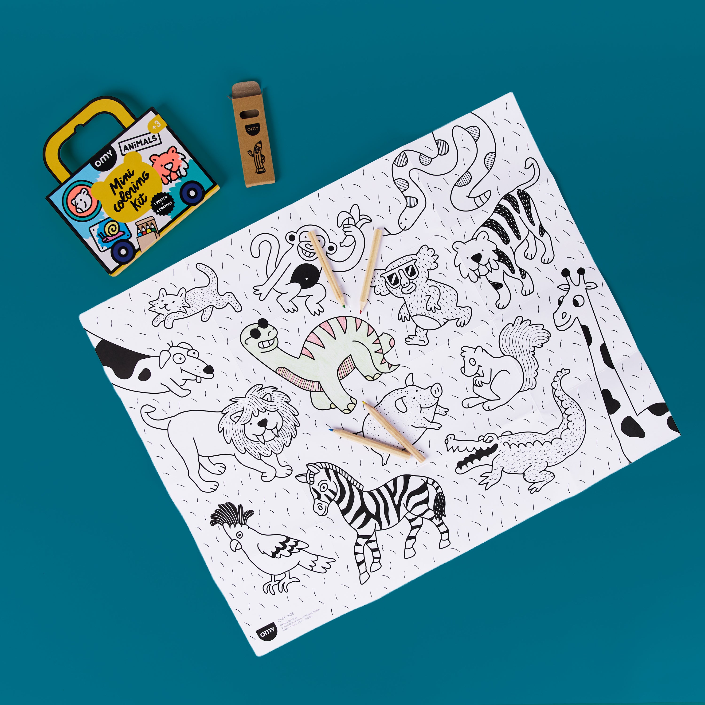 OMY Mini Coloring Kit Animals travel-size coloring set with animal-themed box, mini crayons in cardboard tube, and unfolded poster for kids; portable art kit for creative play.