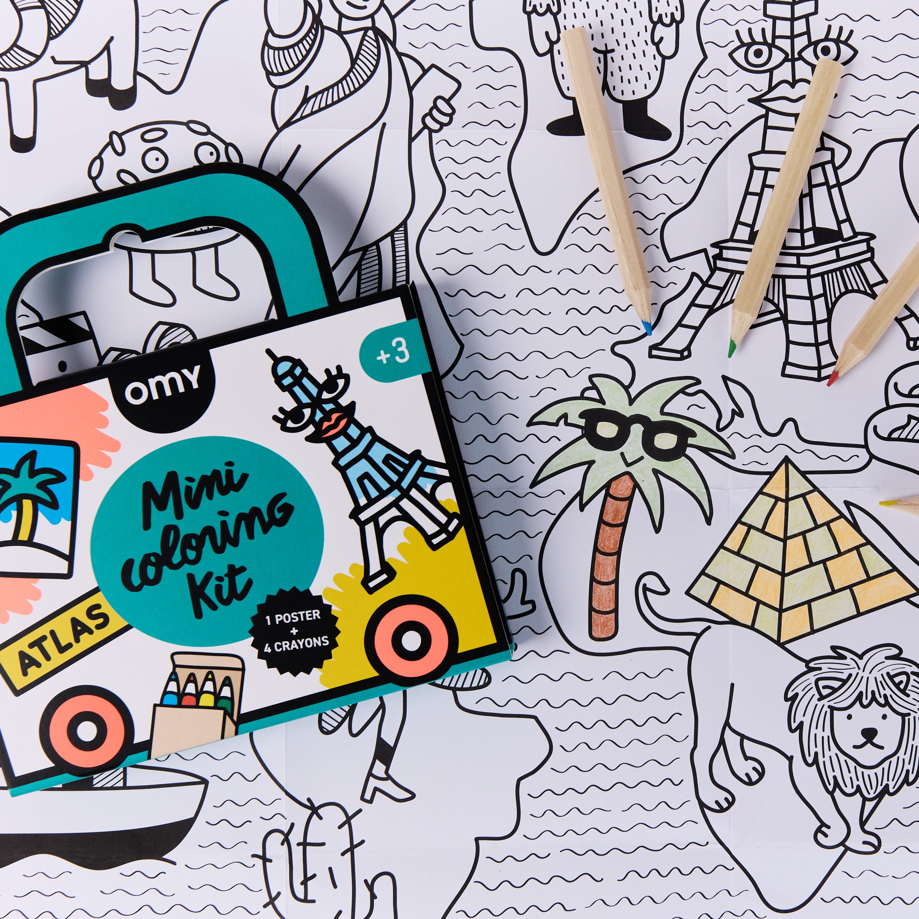 Close-up of OMY Mini Coloring Kit Atlas on world map coloring poster, with colored pencils highlighting pyramids and palm tree – portable travel art set for kids ages 3+.