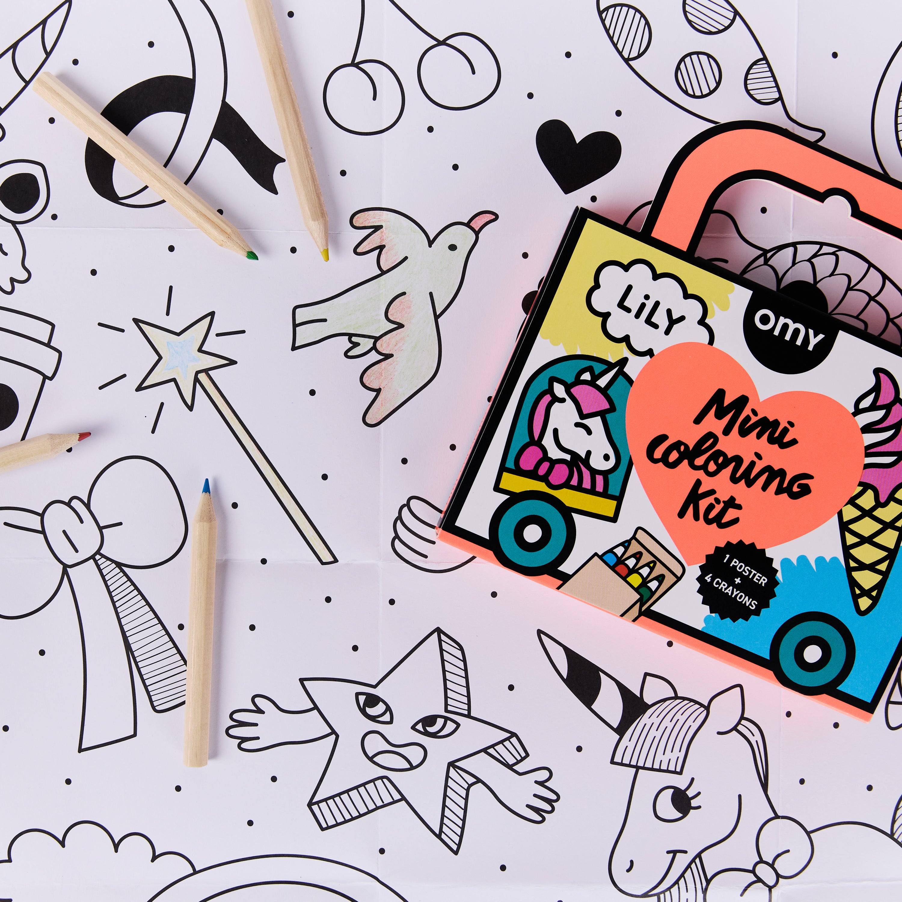 Close-up view of the Mini Coloring Kit - Lily showing unicorn-themed coloring pages and mini wax crayons in the portable orange suitcase, a travel coloring set for kids ages 3-7.