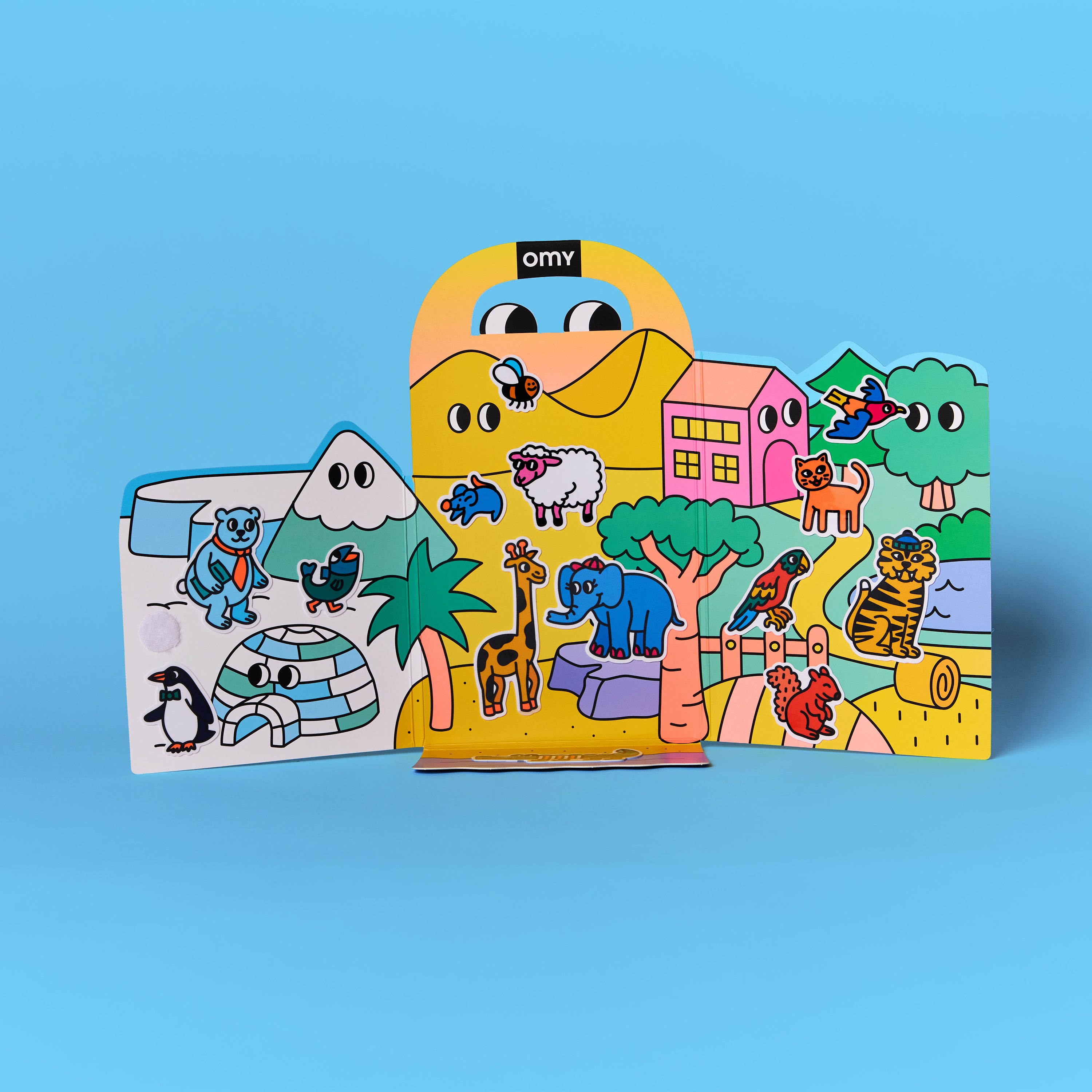 Fold-out stand-up scenes from Montessori animal sticker kit featuring colorful cartoon animals, houses, and landscapes on a blue background.