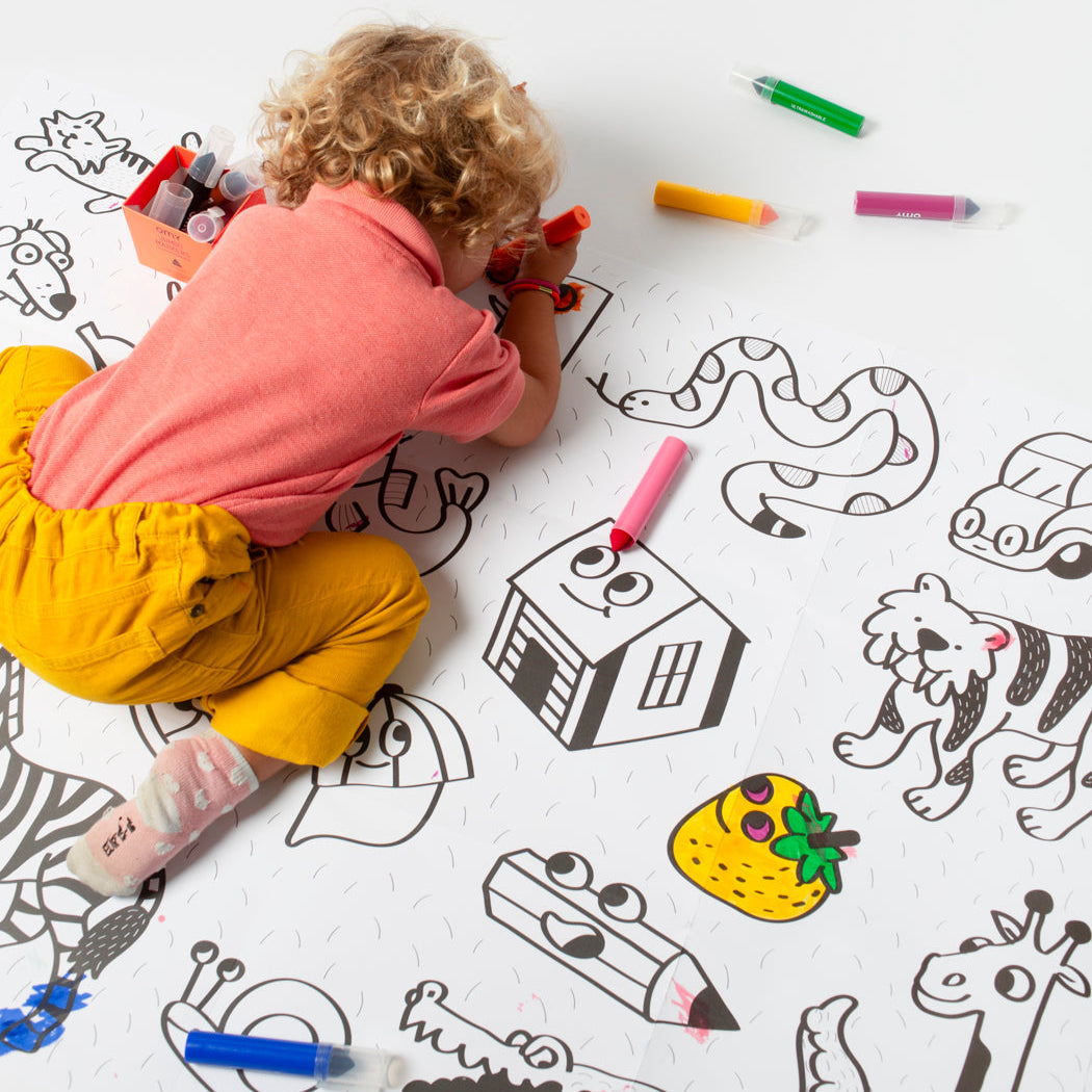 Child coloring on the My First Baby Art Poster with colorful OMY markers