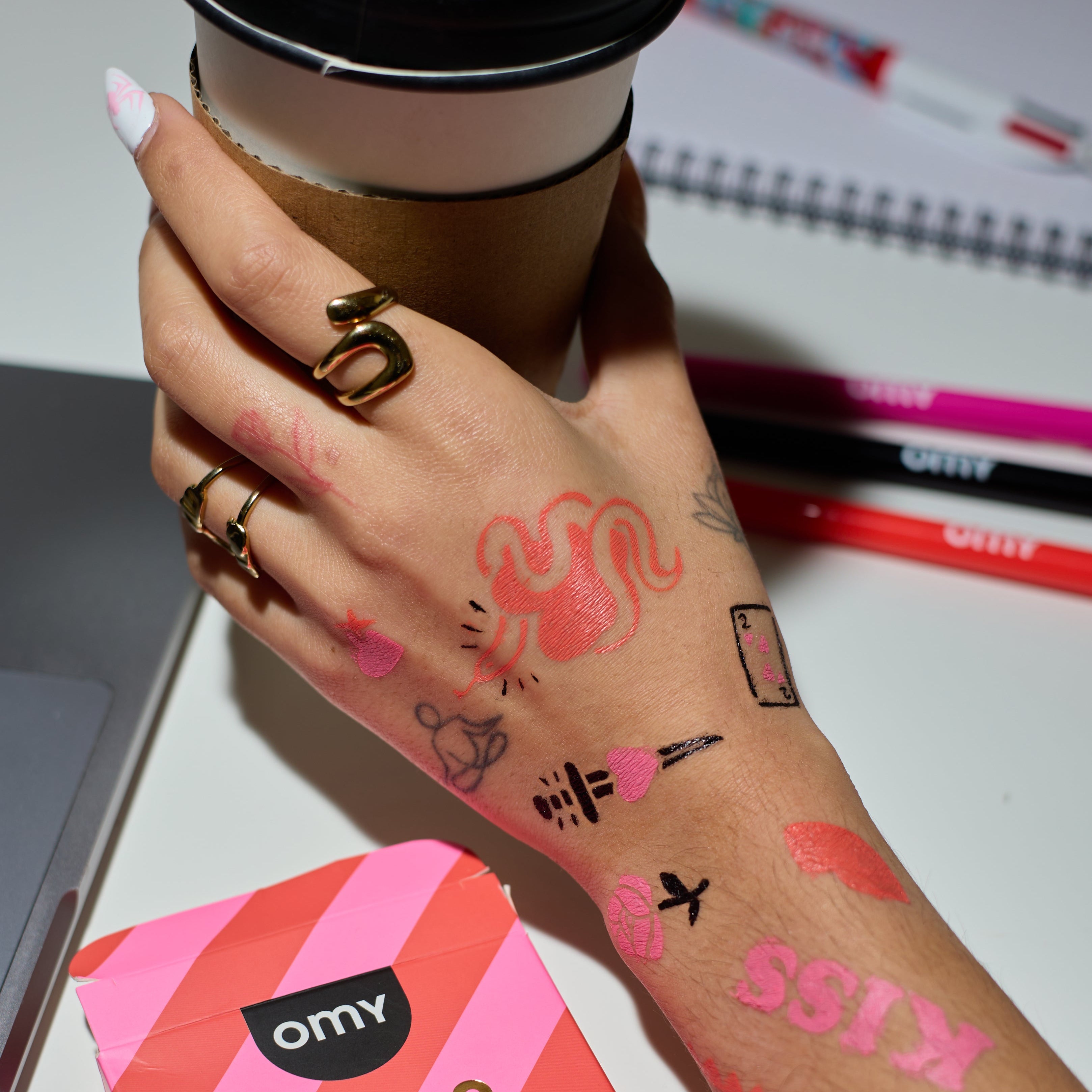 Love-themed temporary tattoos drawn on hand with OMY Tattoo Art skin markers