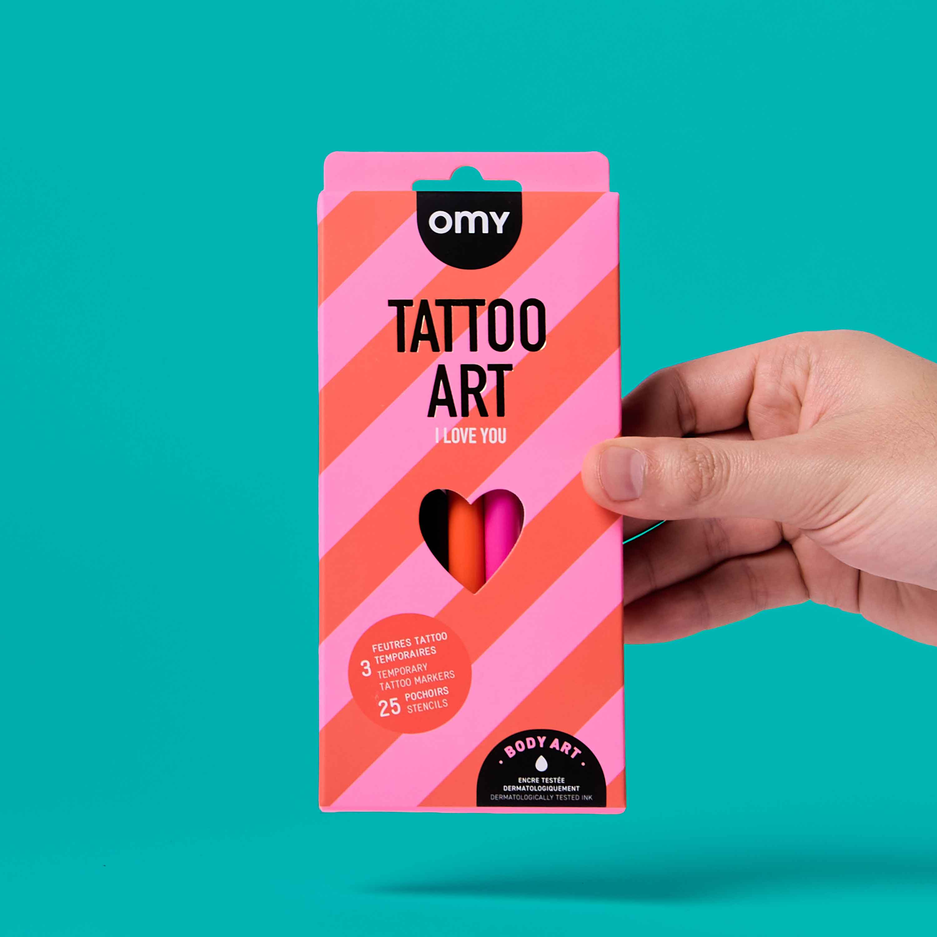 OMY Tattoo Art I Love You temporary tattoo markers kit packaging held in hand on turquoise background