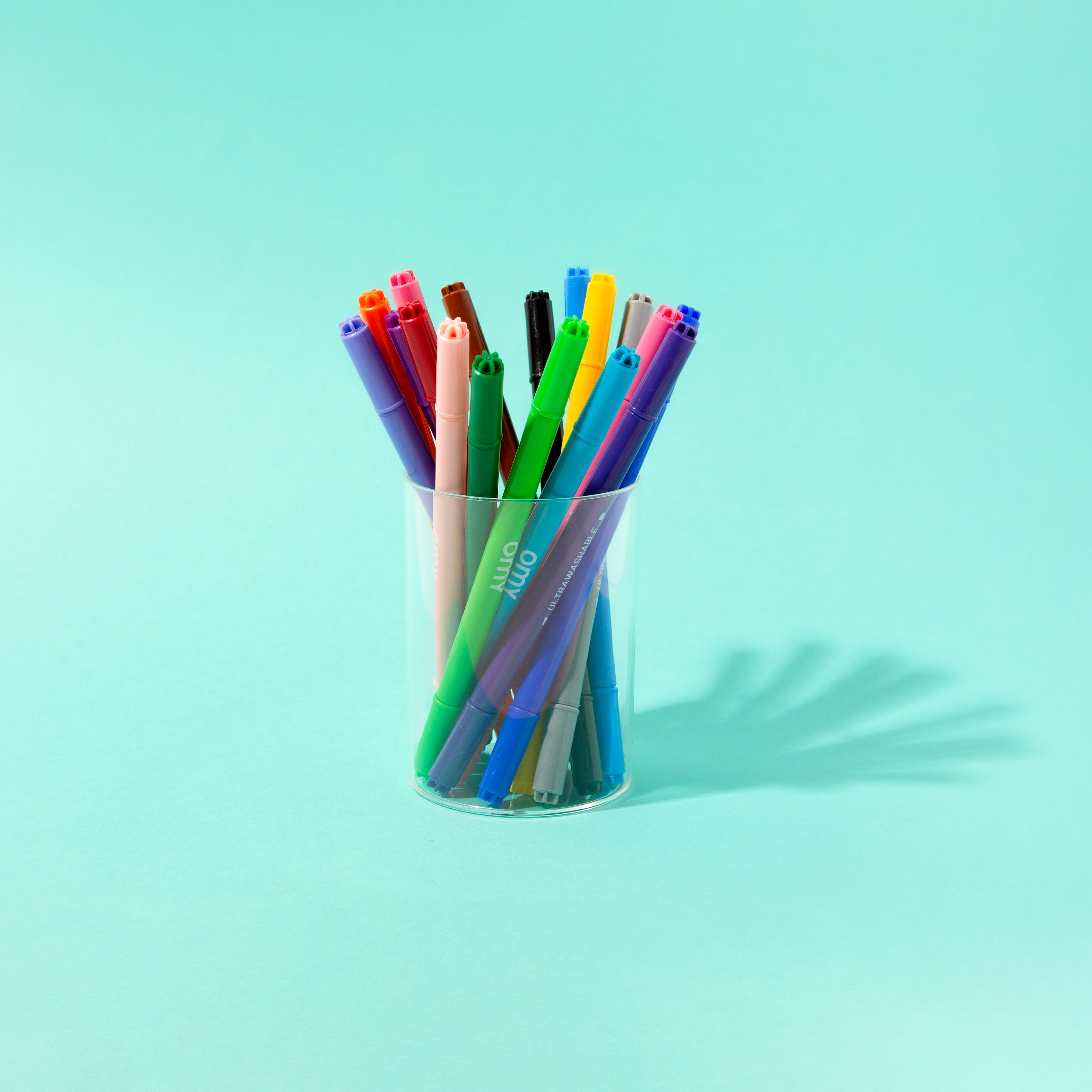 Colorful OMY markers in a pot for kids’ coloring activities, creative drawings and art projects.