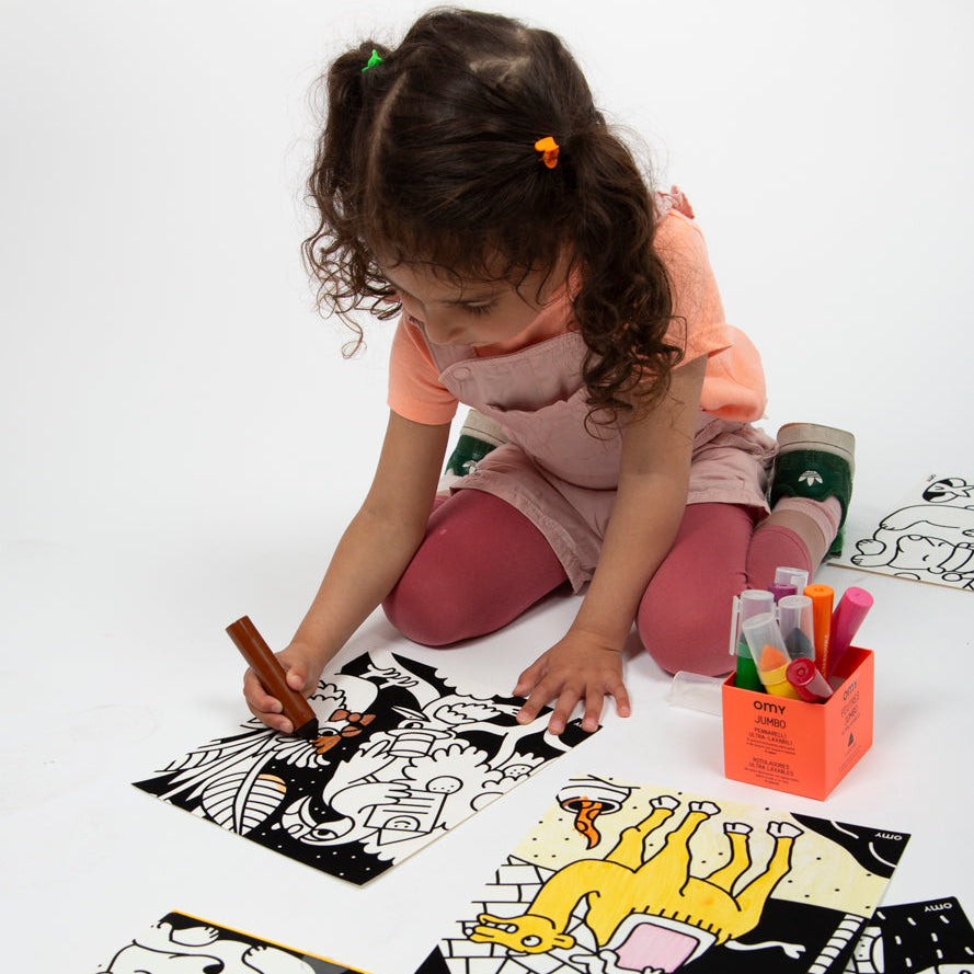 Child coloring the Velvet Animals activity set with OMY markers