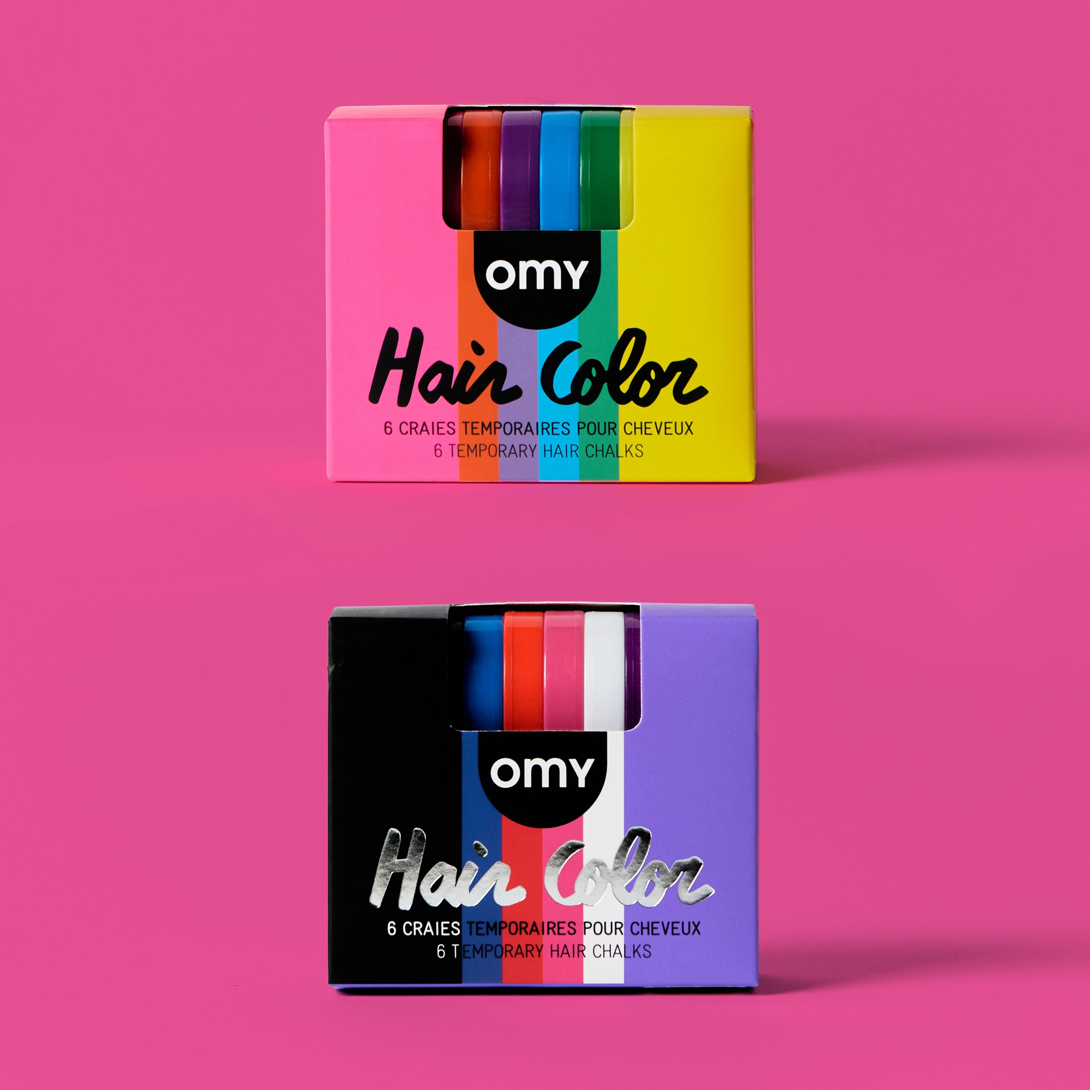 Two boxes of omy temporary hair color on a pink background