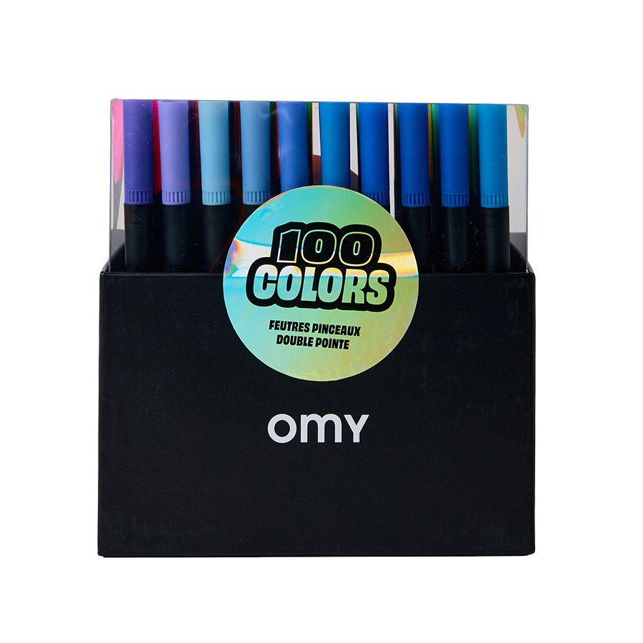 A box of Omy 100-color double pointed paint pens, showing a variety of vibrant colors in a clear top section above a black base 