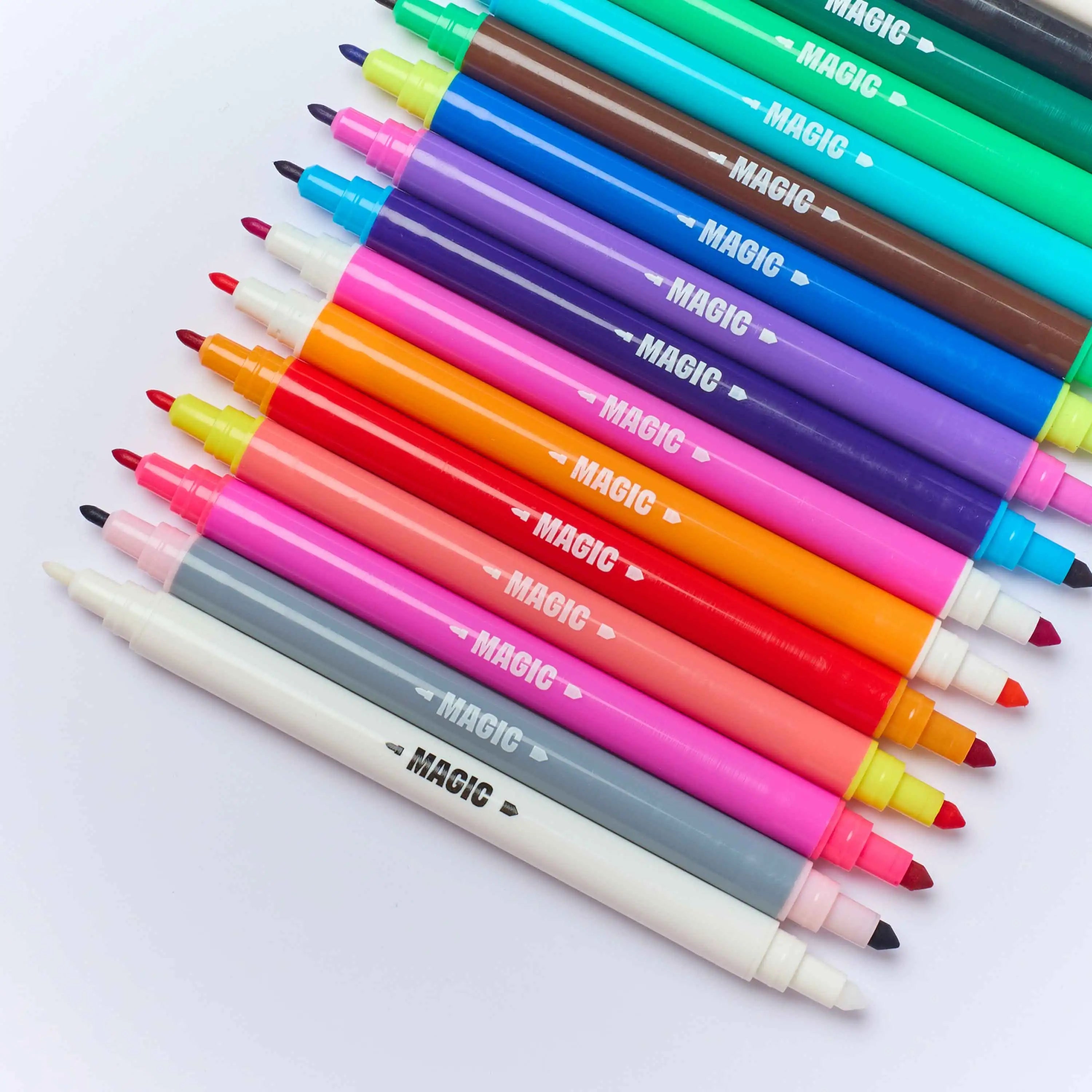 OMY Magic Twist 16 color-changing dual-tip markers close-up – flat lay showing both tips of each pen in rainbow colors including teal, brown, green, blue, purple, orange, red, pink, gray and white on white background