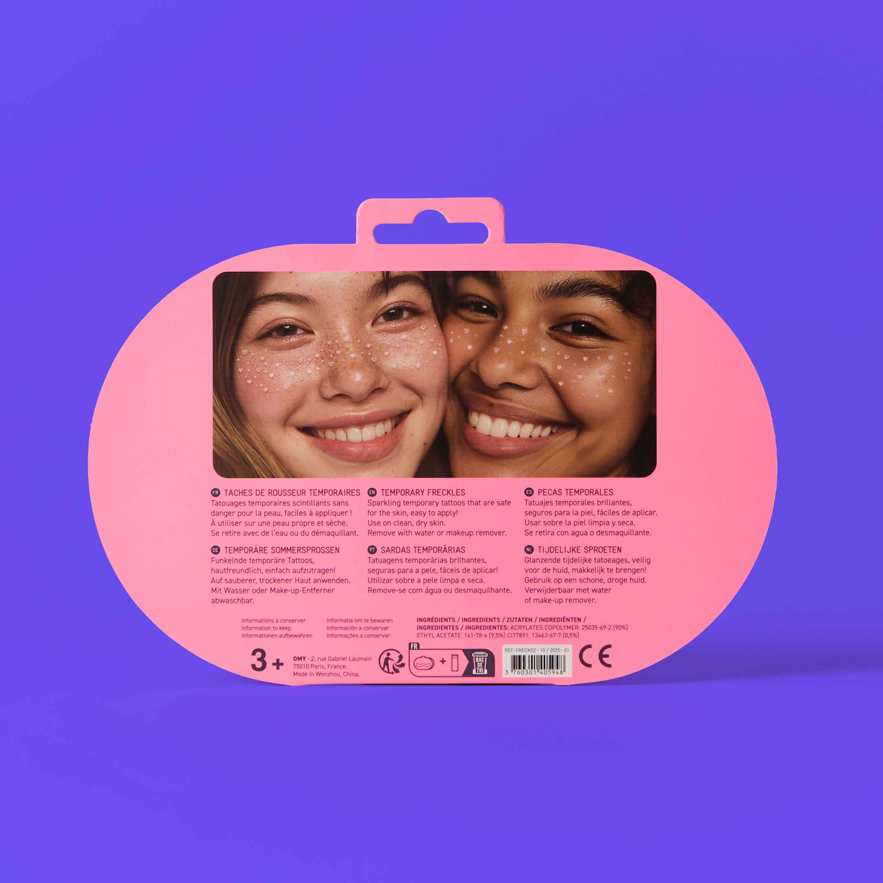 Pink packaging of Freckle Tattoos OMY on a purple background