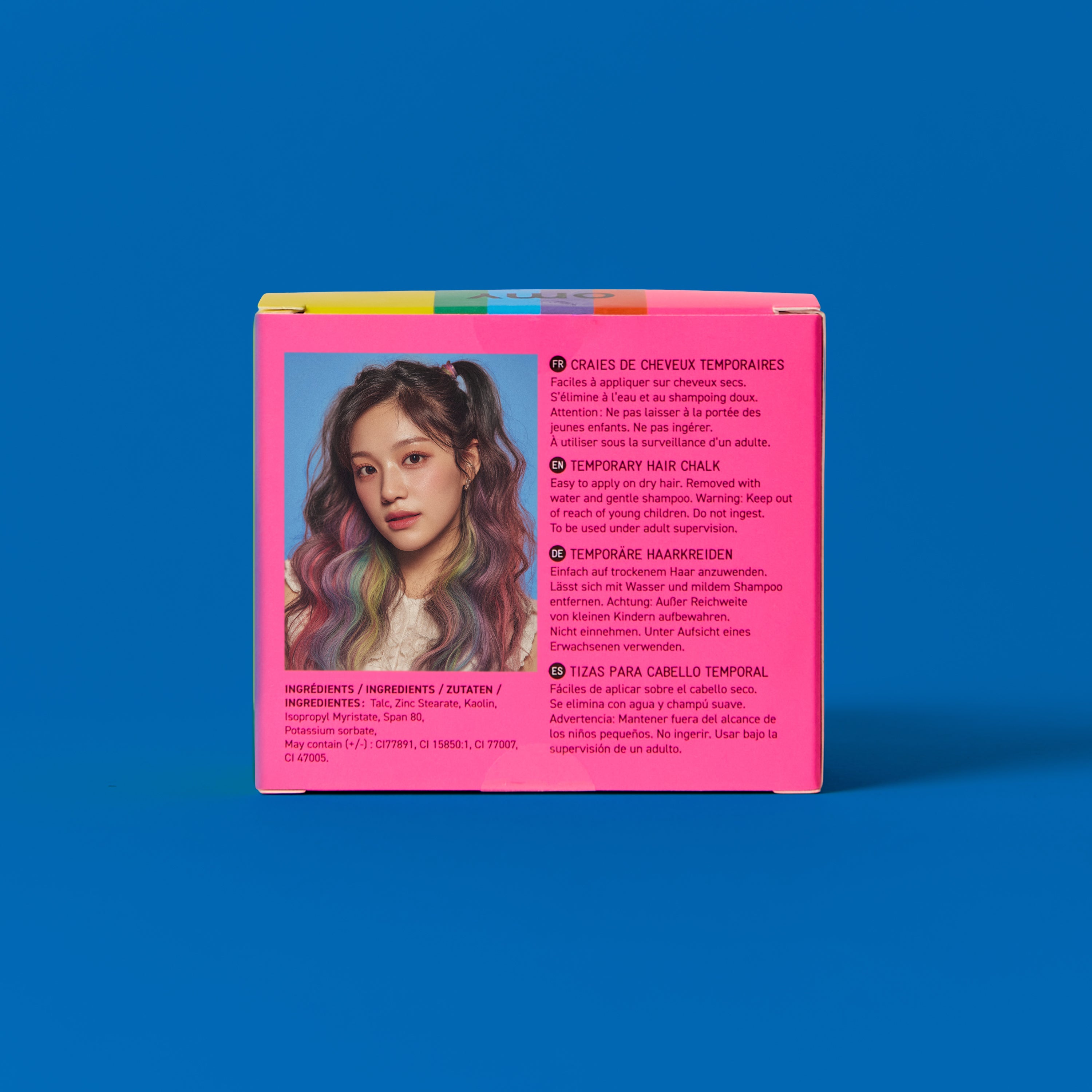 Back of OMY Hair Color Rainbow packaging – pink box showing a girl with colorful rainbow hair chalk highlights and multilingual usage instructions on blue background