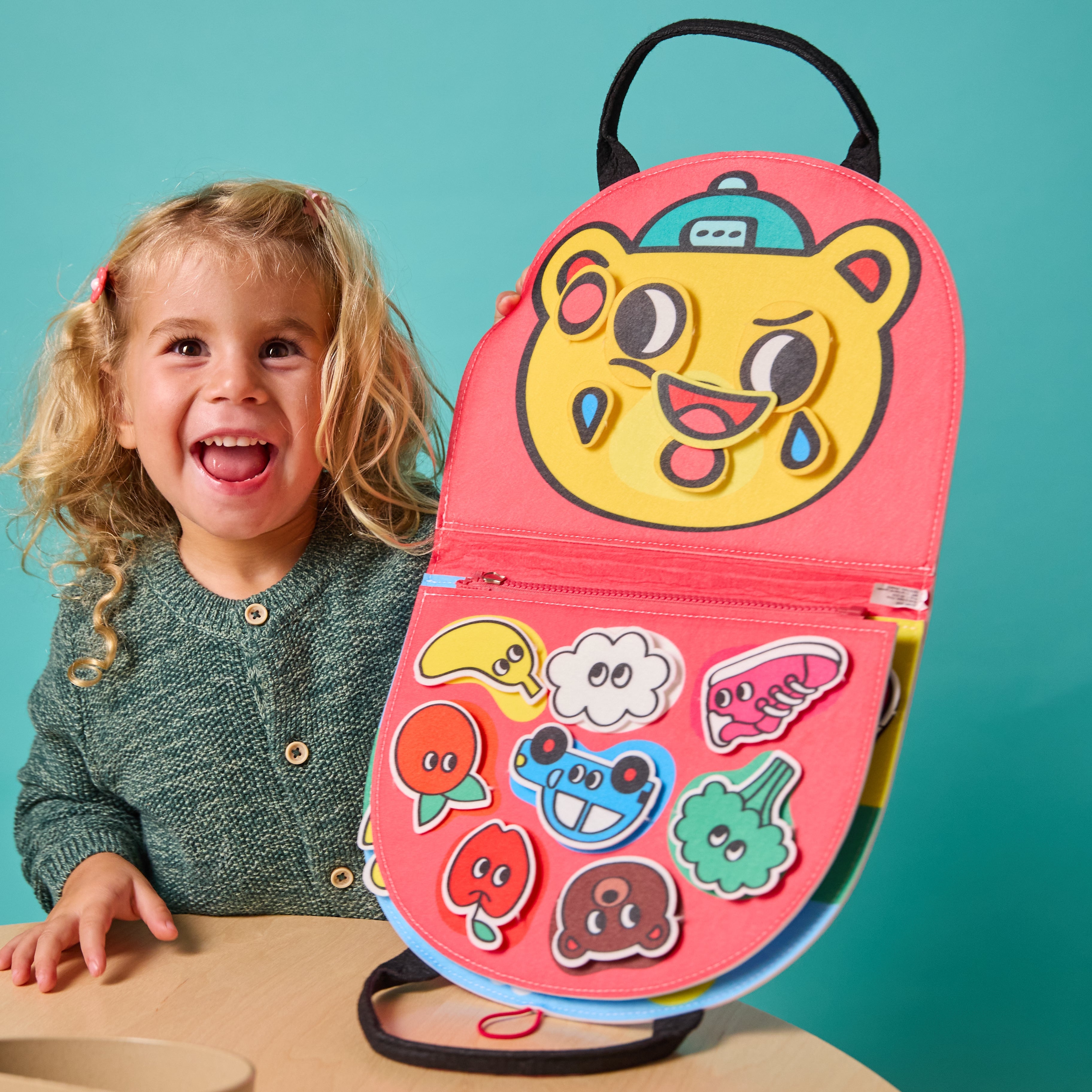 Toddler interacting with Montessori playkit — sensory matching game with fruits, objects, and colors.