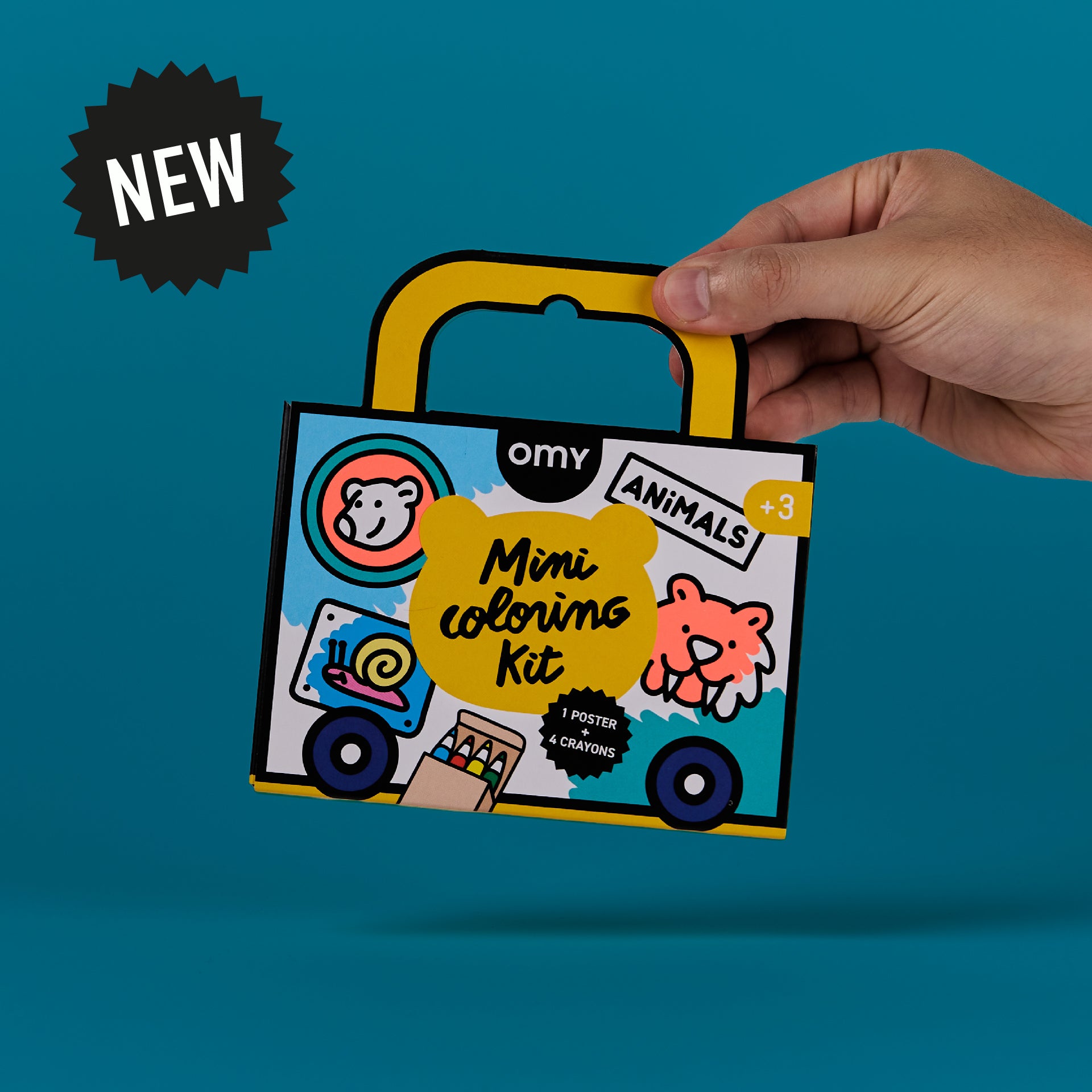 Hand holding OMY mini coloring kit with animal-themed illustrations on the box; portable coloring set with handle for kids travel.