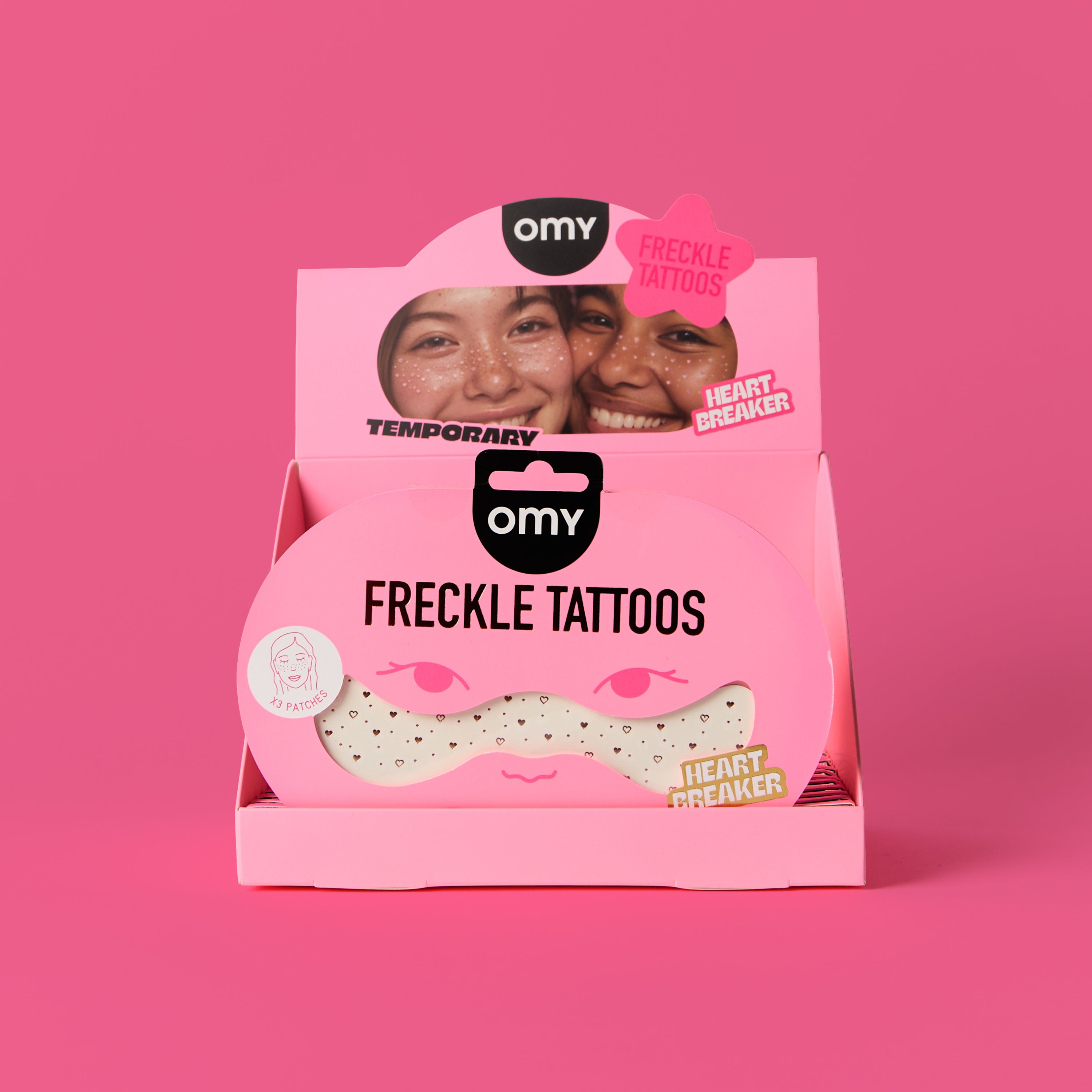 Pink packaging of OMY freckle tattoos on a pink background