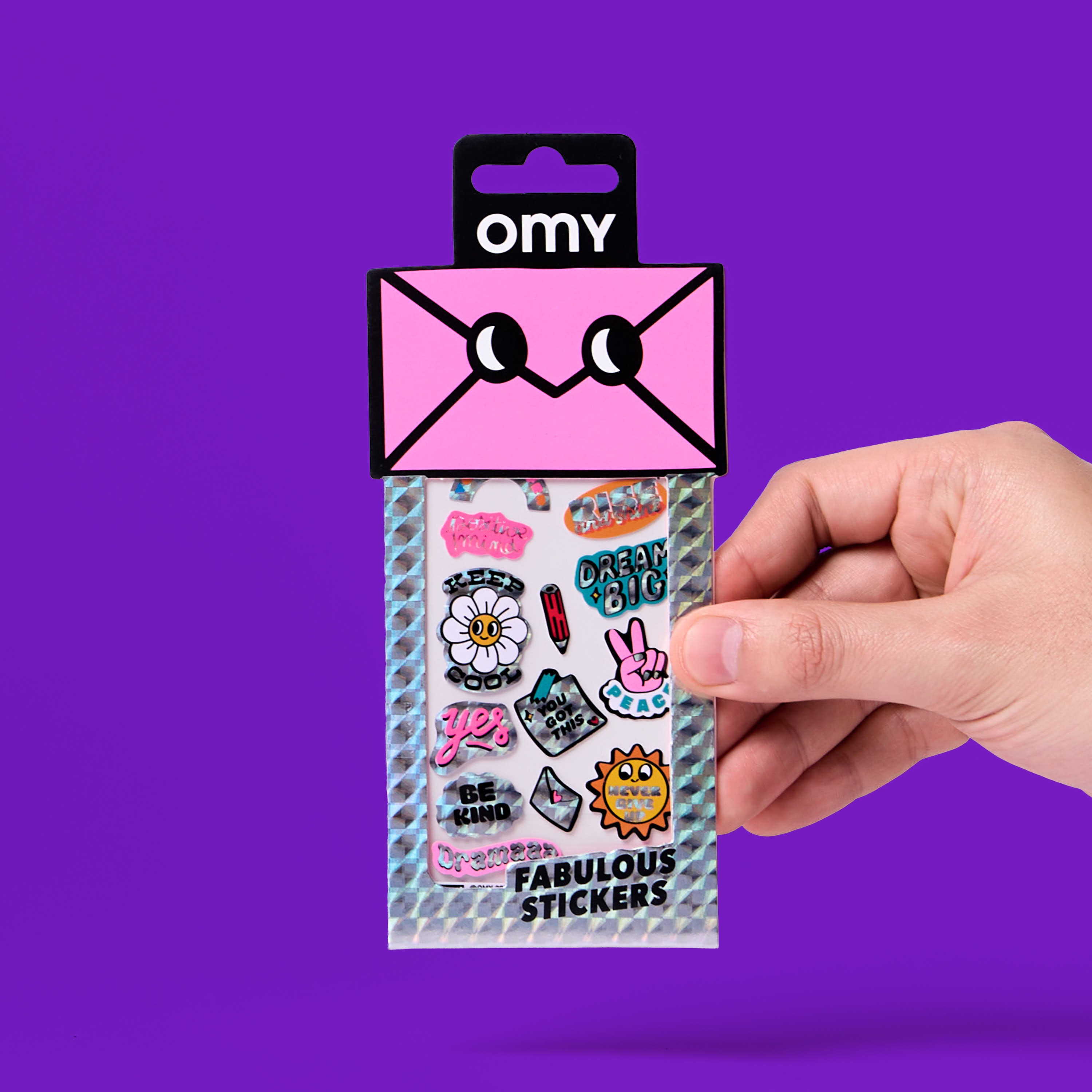 Pack of stickers iconic messages OMY held by a hand against a purple background