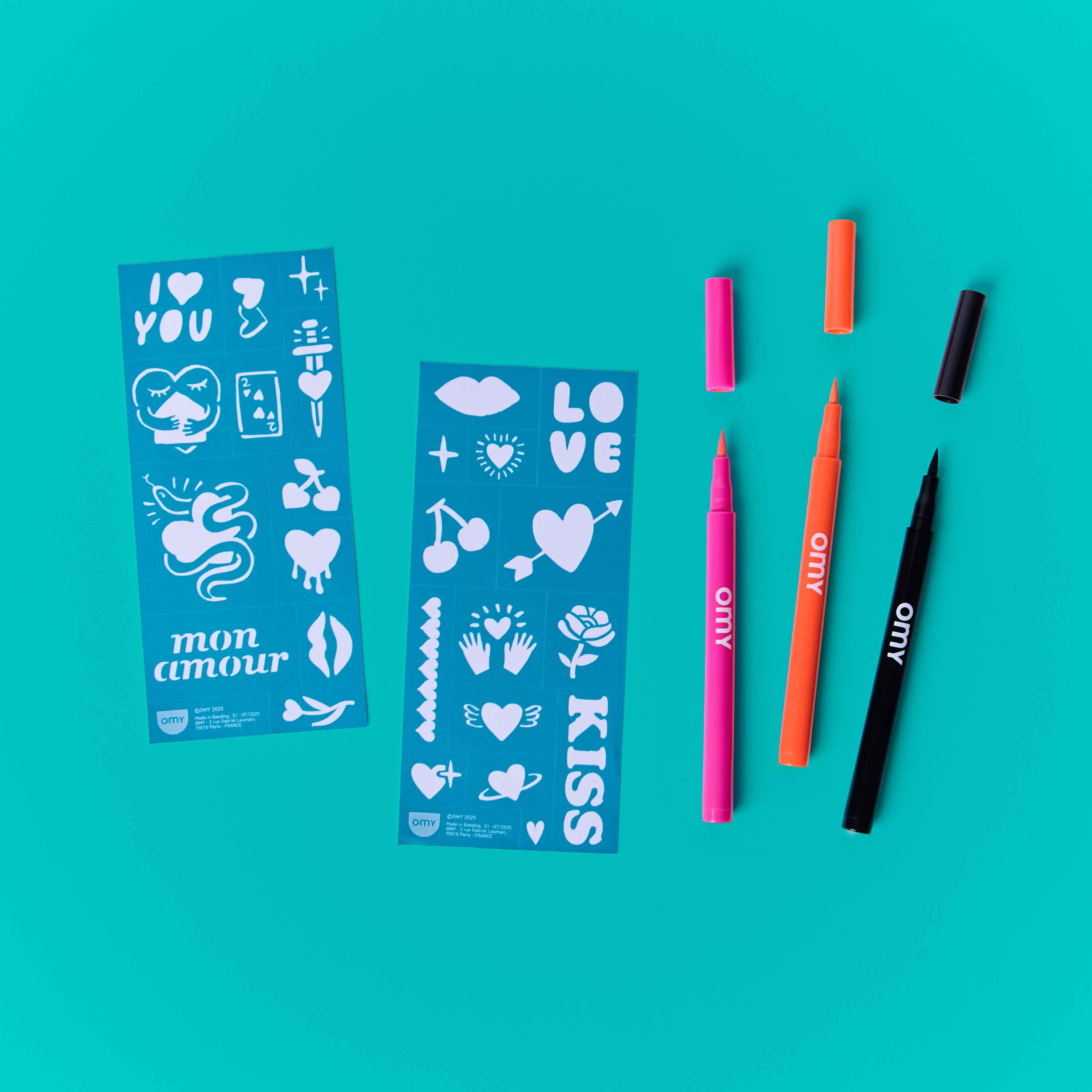 OMY Tattoo Art I Love You kit with temporary tattoo markers and love-themed stencils on turquoise background